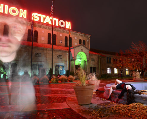 behind the mask, Chris Moss, image of girl laying on the ground with man in the other side of the picture and old building in the background