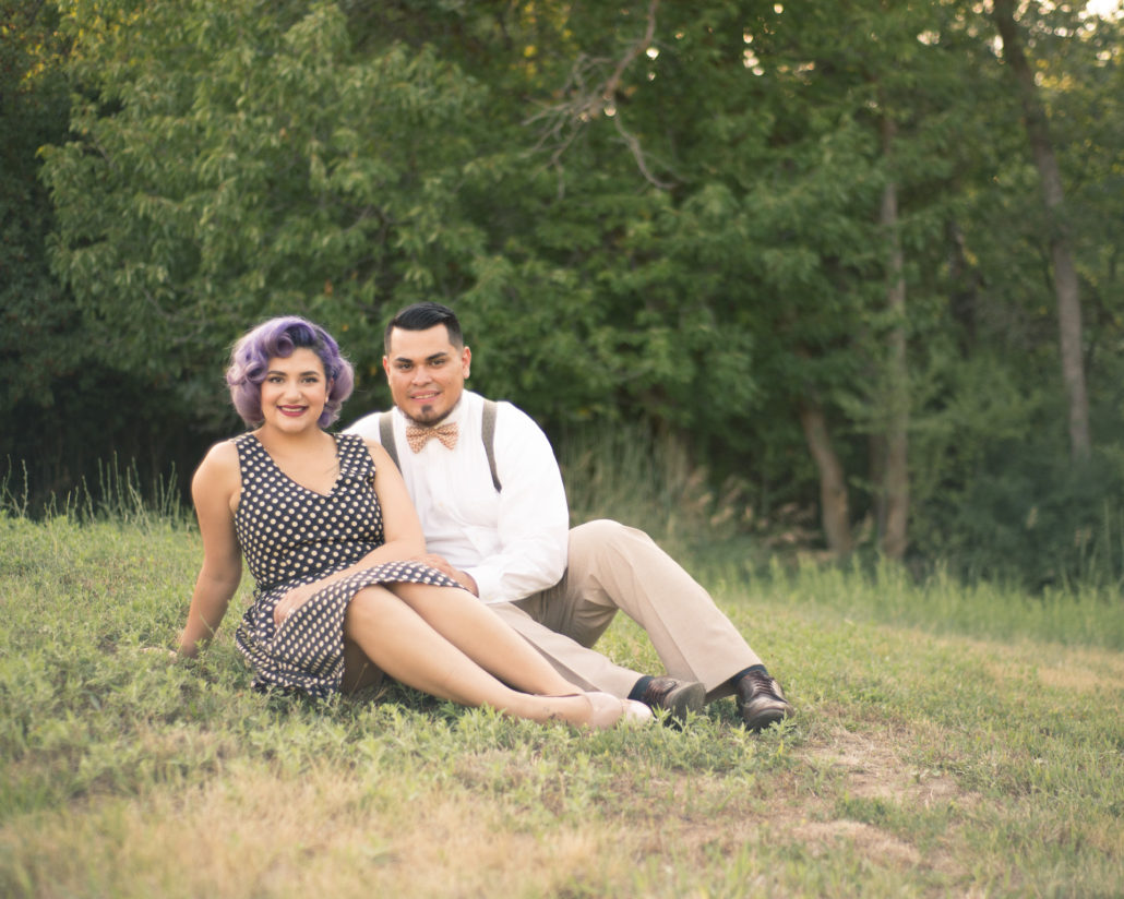 Wedding, Moss Image, Moab Photographer, Portrait, Chris Moss, picture of a man and woman holding each other sitting in a field with green trees in the background