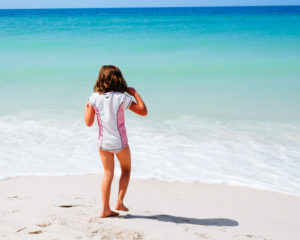 Girl on beach blue water white sand, moss image, moab photographer, chris moss