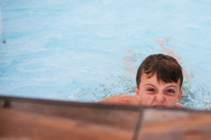 kid playing in pool, cuba, travel